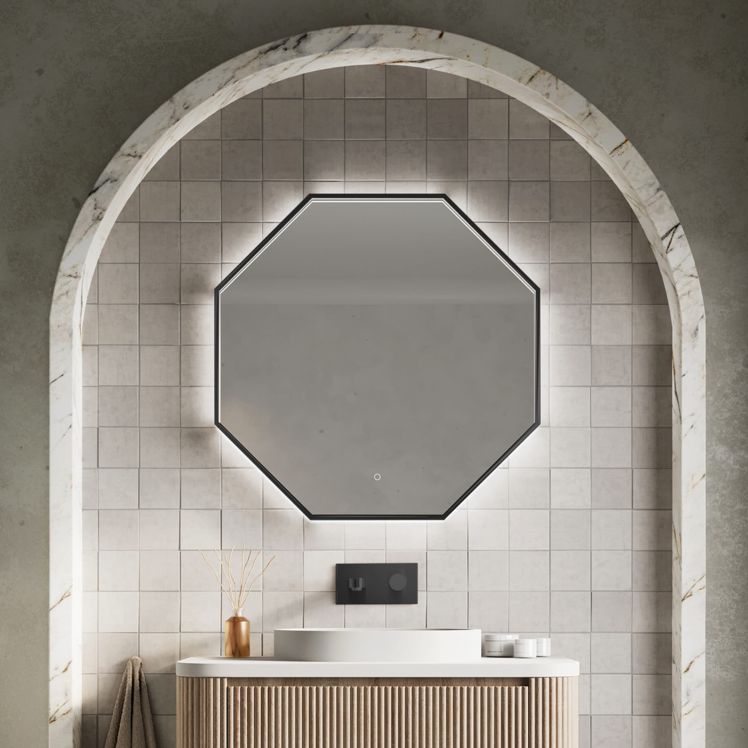 Black-edged octagonal mirror above a basin in an arched tiled alcove
