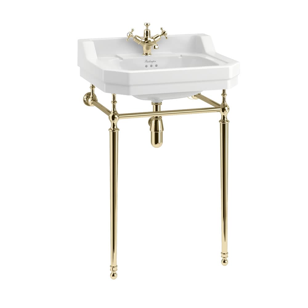 White basin on a gold-coloured washstand with exposed trap and crosshead taps.