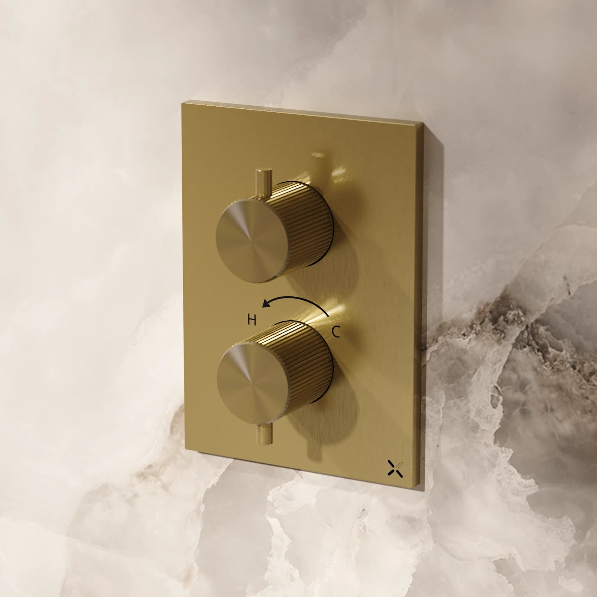 Two brass-coloured concealed shower controls on a pale stone wall