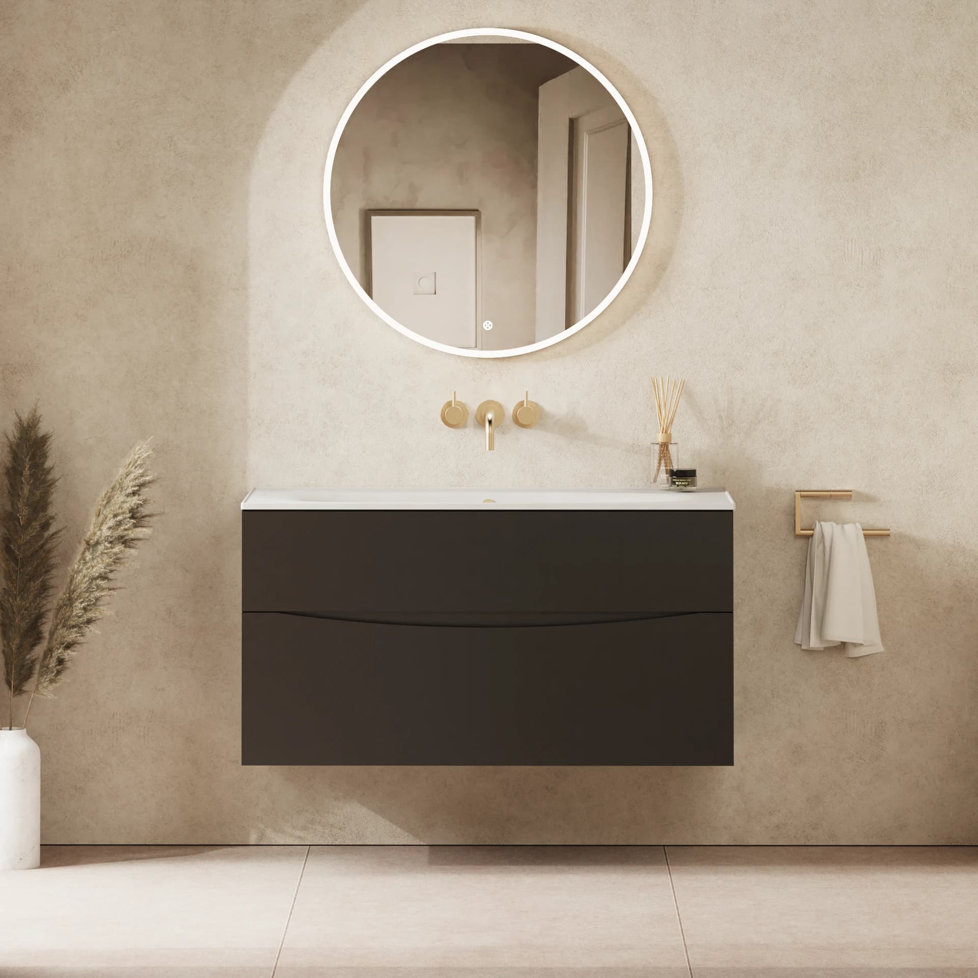 Dark wall-mounted vanity and white basin beneath a round illuminated mirror.
