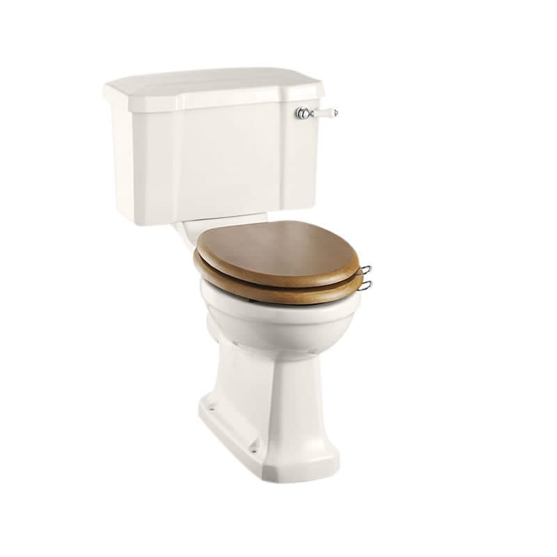 Traditional white close-coupled toilet with a lever cistern and brown wooden seat